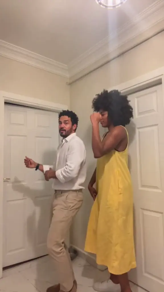 Side-by-Side Room Dance: Two dancers turn forward together for matching steps, hand hearts and arm flexes.
